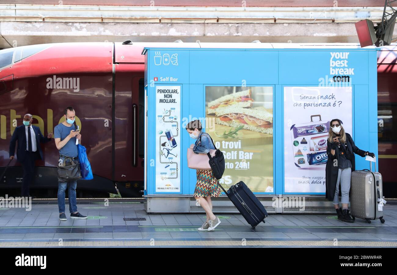 Rome, Italy. 3rd June, 2020. Passengers wearing face masks wait for a train  at Roma Termini Train Station in Rome, Italy, June 3, 2020. Italy's active  infections of coronavirus fell below 40,000