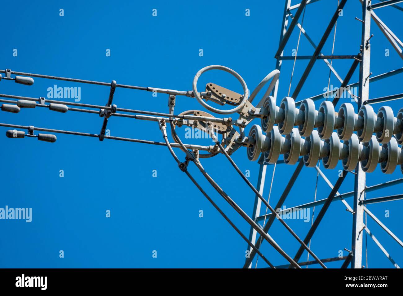 Close up details of sections of a high voltage electricity pylon against a vivid blue sky Stock Photo