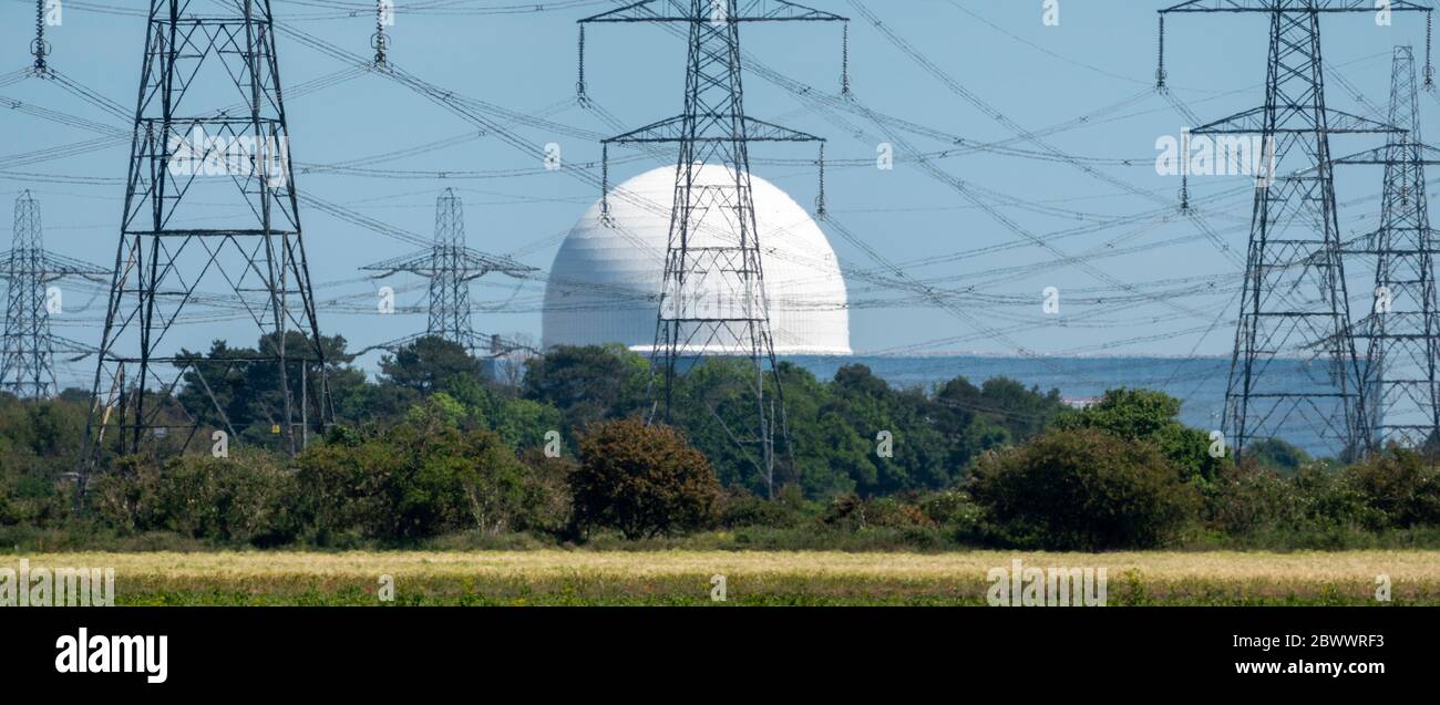 Sizewell B Nuclear Power Plant with several electricity pylons in front seen through a distorting heat haze in monochrome Stock Photo