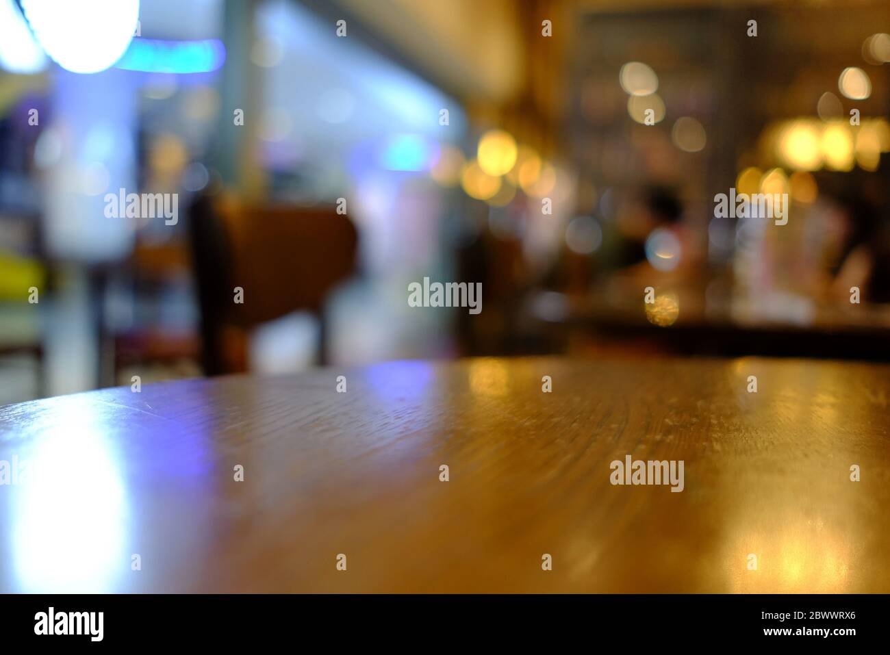 Close up Surface of Wooden Table in Cafe with Bokeh Background. (Selective Focus) Stock Photo