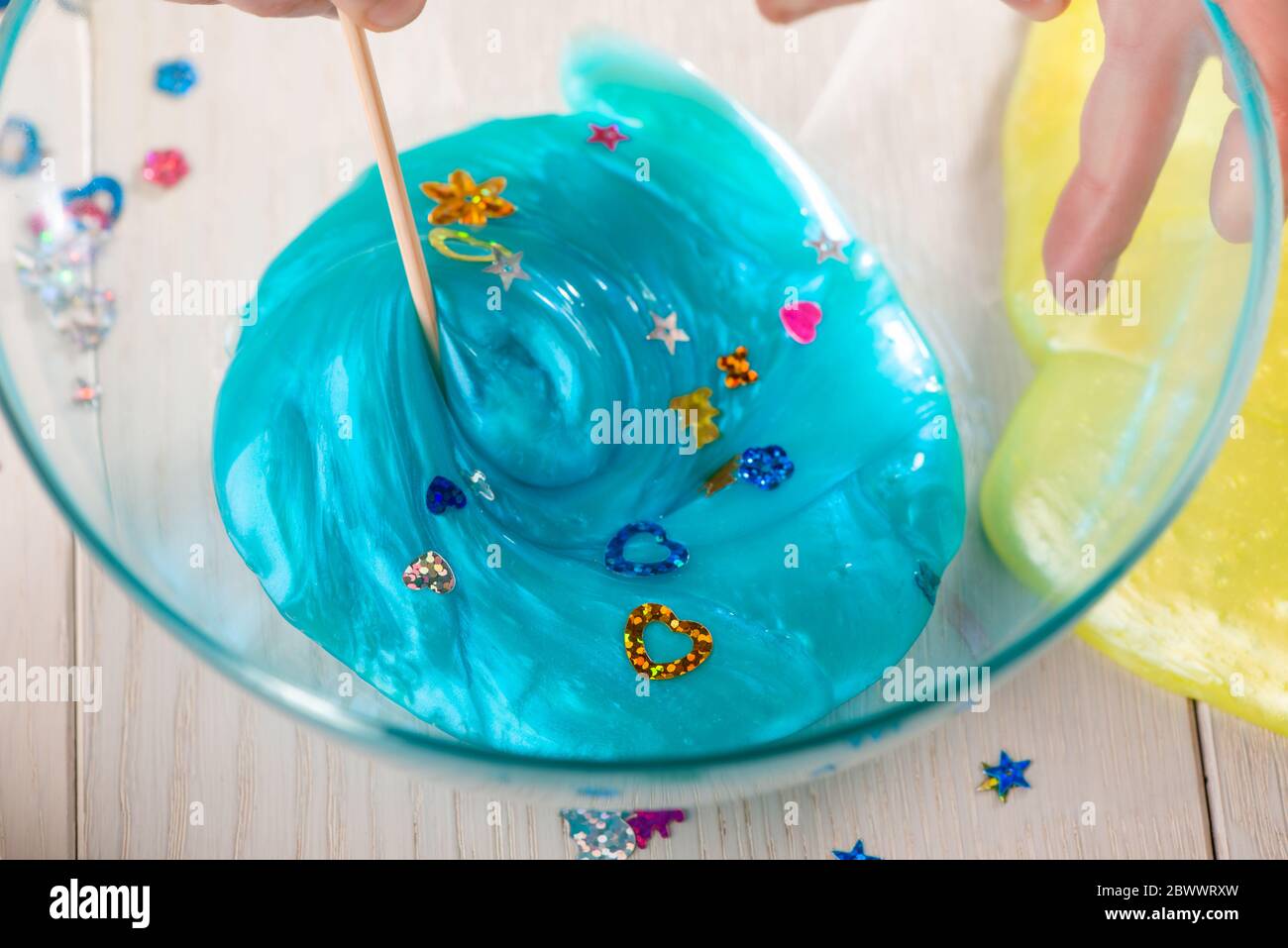 Girl mixing ingredients to make a slime Stock Photo - Alamy