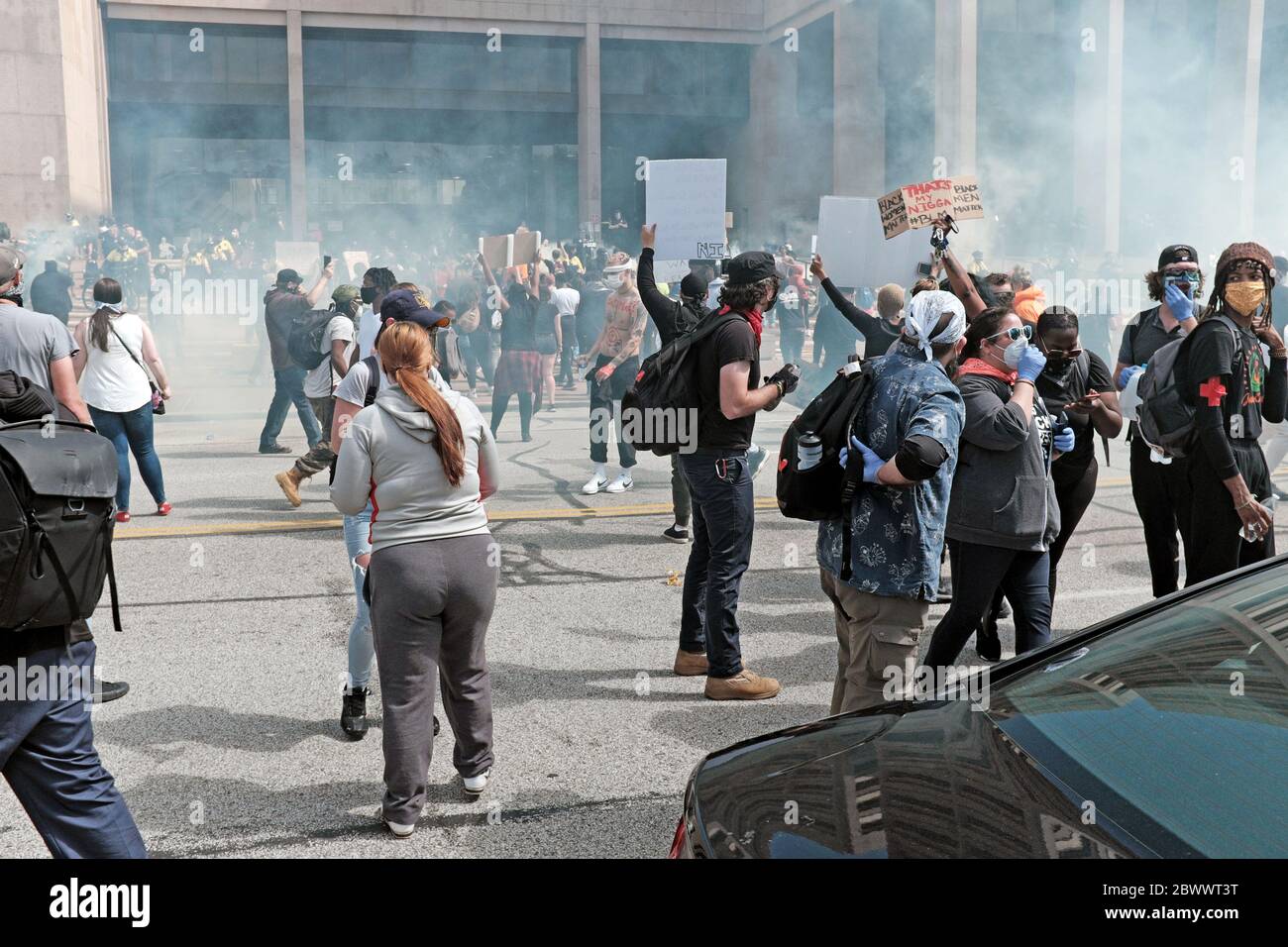 Cleveland, Ohio, USA. 20 May, 2020.  Chaos ensues following a peaceful Black Lives Matter march through Cleveland, Ohio, USA.  Thousands of protesters against police abuse against blacks in the US marched to the Justice Center on Lakeside Avenue where the peaceful gathering turned violent with tear gas, chemicals, and plastic bullets were used against them by the Cleveland police. The Justice Center, headquarters for the Cleveland Police, was a primary target of protesters before spreading their ire throughout downtown where busineses were looted and vandalized resulting in a six day curfew. Stock Photo