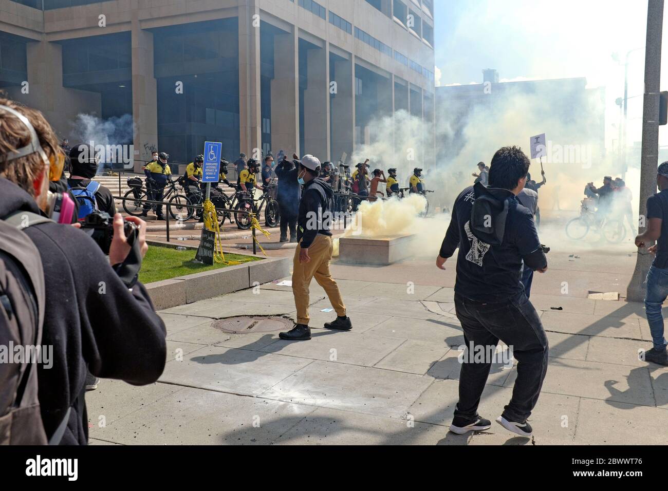 Tear gas is used by Cleveland Police to disperse protesters outside the Justice Center in downtown Cleveland, Ohio, USA.  Activists protesting police brutality in America and racial relations between the police and the communities they serve results in chaos outside the Justice Center, headquarters of the Cleveland Police, which spread throughout downtown Cleveland on May 30, 2020. Stock Photo