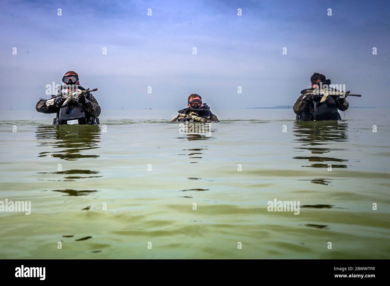 U.S. Marines with 3rd Reconnaissance Battalion, patrol through water during a Marine Corps Combat Diving Supervisors Course at Camp Schwab May 20, 2020 in Okinawa, Japan,. Stock Photo