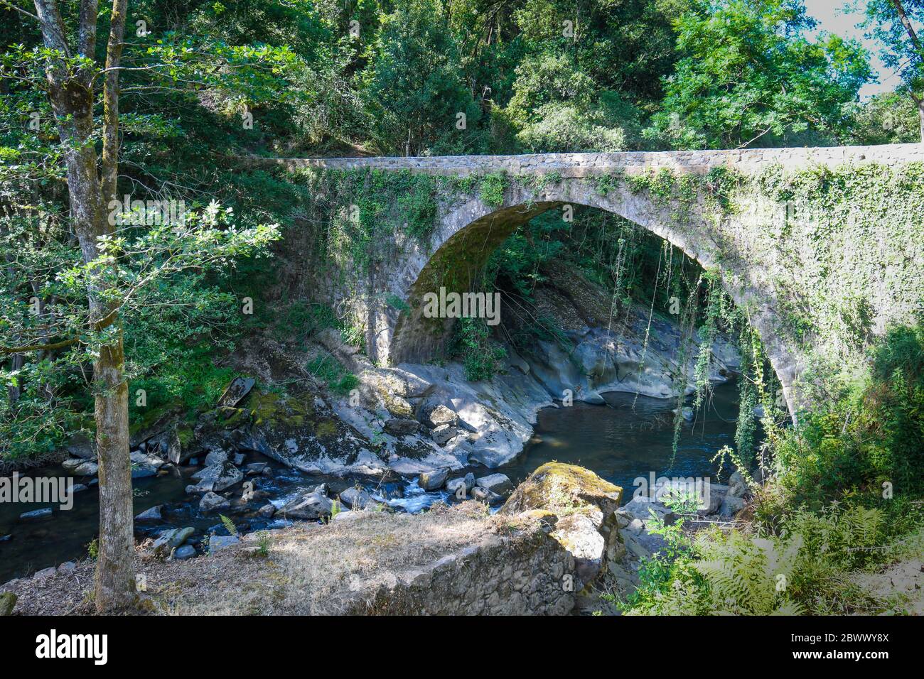 Bridge over the Barbadún river as it passes through the La Olla ironworks in Galdames Stock Photo