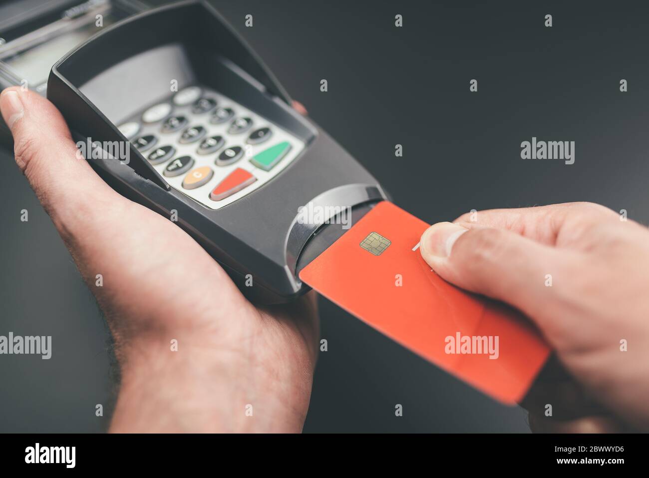 person inserts credit card or debit card into POS payment terminal or credit card reader Stock Photo