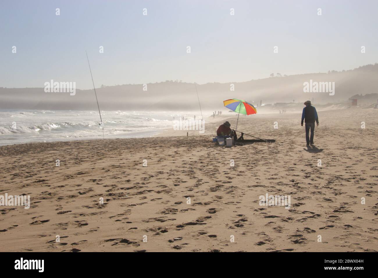 The beach of Wilderness and wild Indian Ocean on Garden Route, South Africa, Africa. An angler on the beach. Stock Photo
