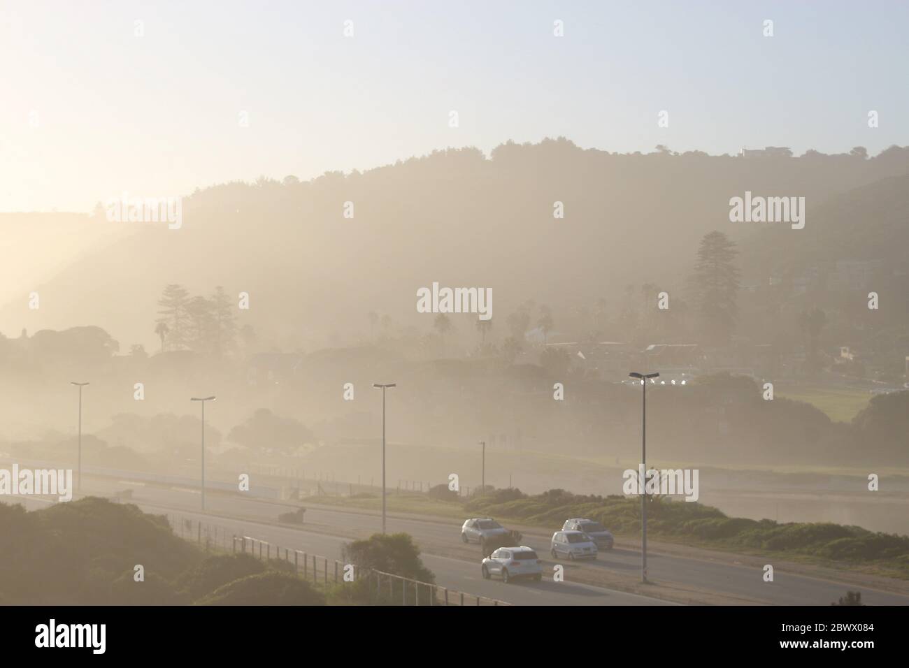Street next to the beach of Wilderness on Garden Route, South Africa, Africa. The air is dusty because of the strong wind and high surf. Stock Photo