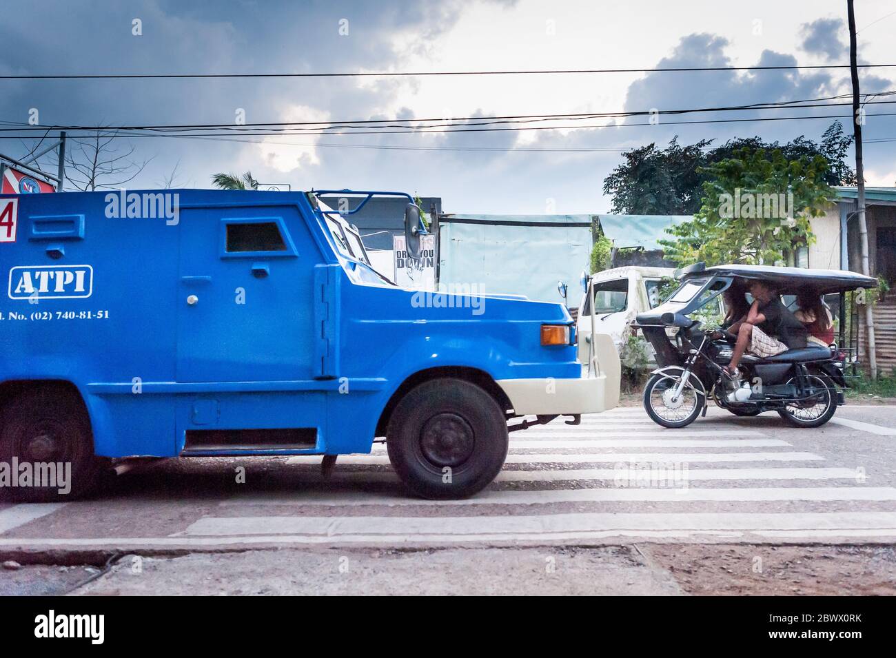 An armoured security van makes its way through Coron Town, Coron Island Palawan The Philippines. Stock Photo