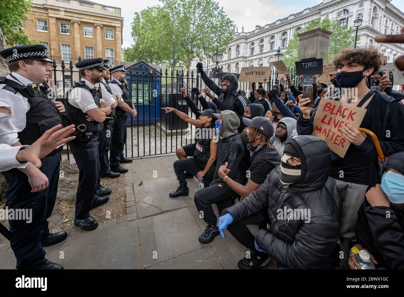 Black Lives Matter (BLM) activists and supporters confront police in Westminster angrily demanding all officers take a knee in show of solidarity support for the Black Lives Matter movement following the death of George Floyd, a black man, who died in police custody on 25th May in Minneapolis. London, UK. Stock Photo