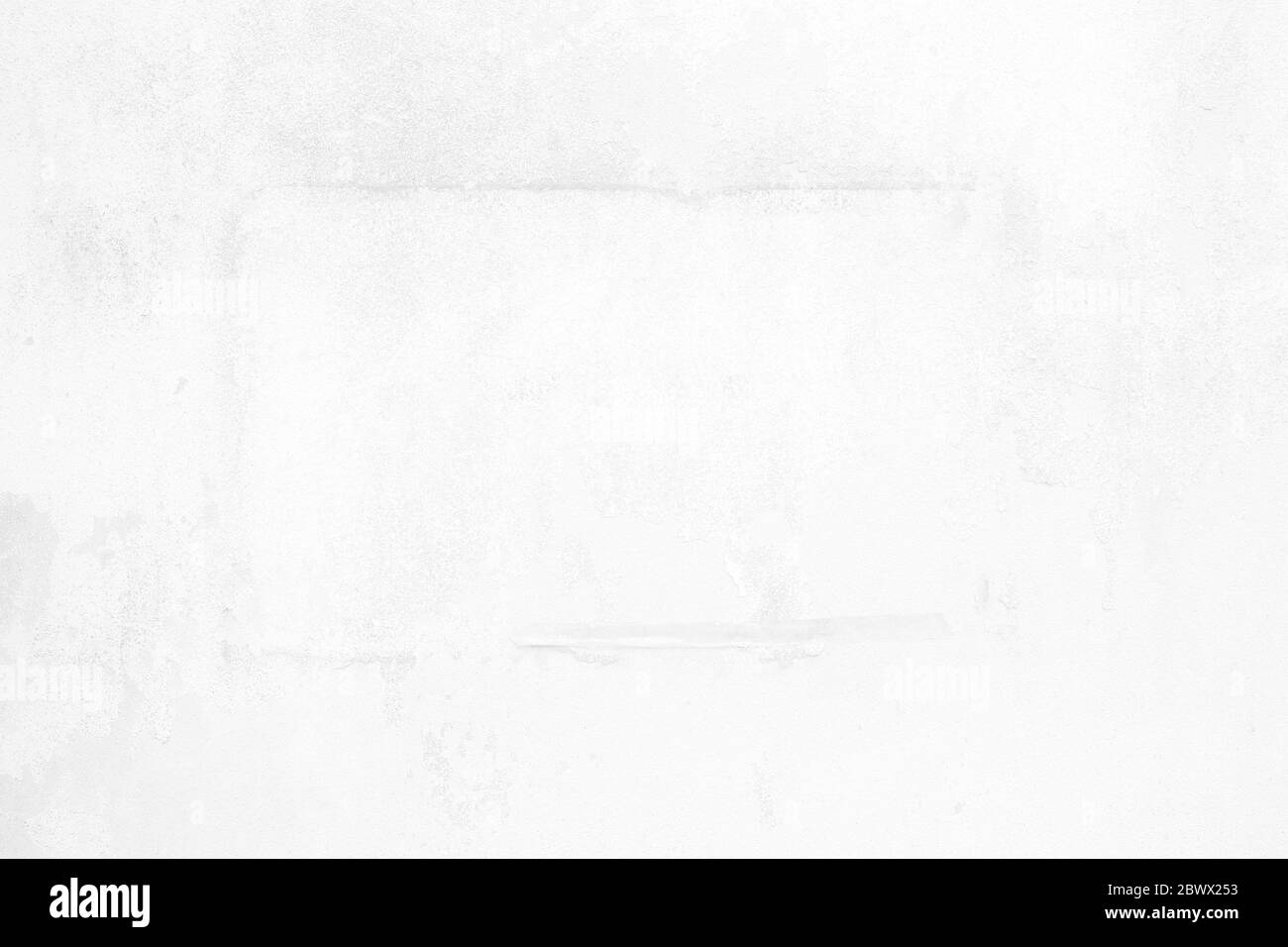 Old Peeling Poster on White Concrete Wall Texture Background. Stock Photo