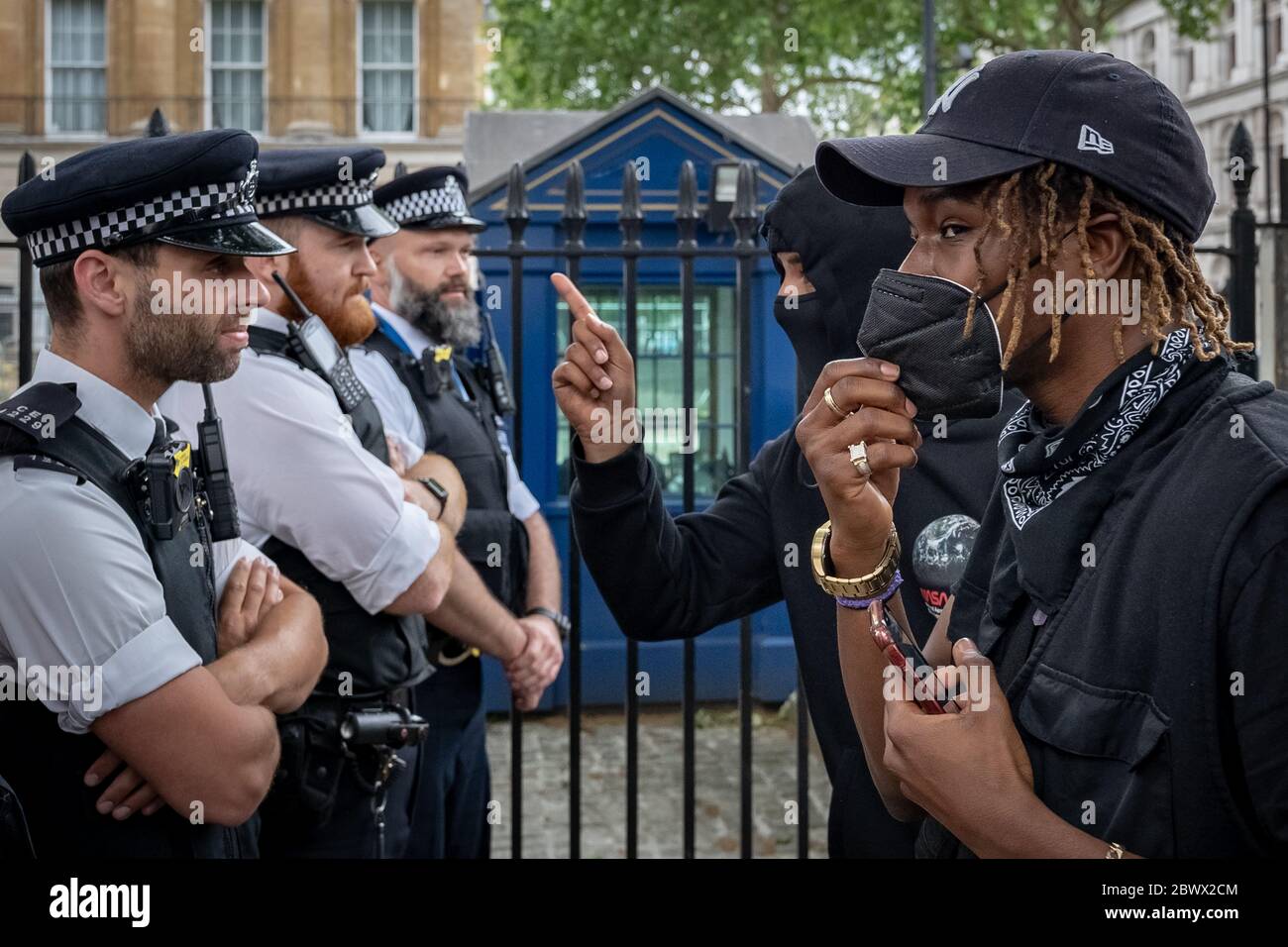 Black Lives Matter (BLM) activists and supporters angrily confront police in Westminster following the death of George Floyd, a black man, who died in police custody on 25th May in Minneapolis. London, UK. Stock Photo