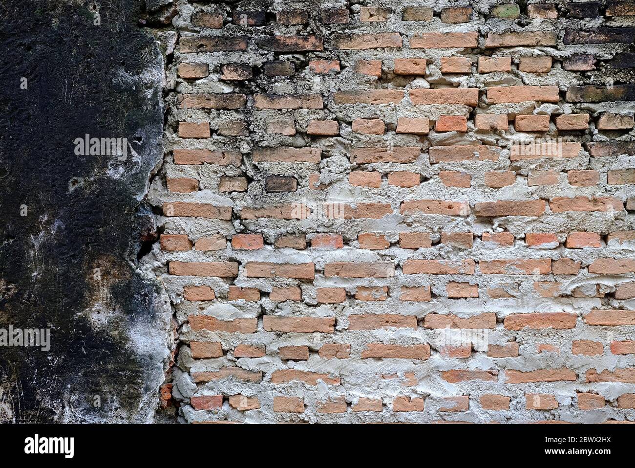 Reconstructed Old Concrete Wall Background with New Bricks Stock Photo