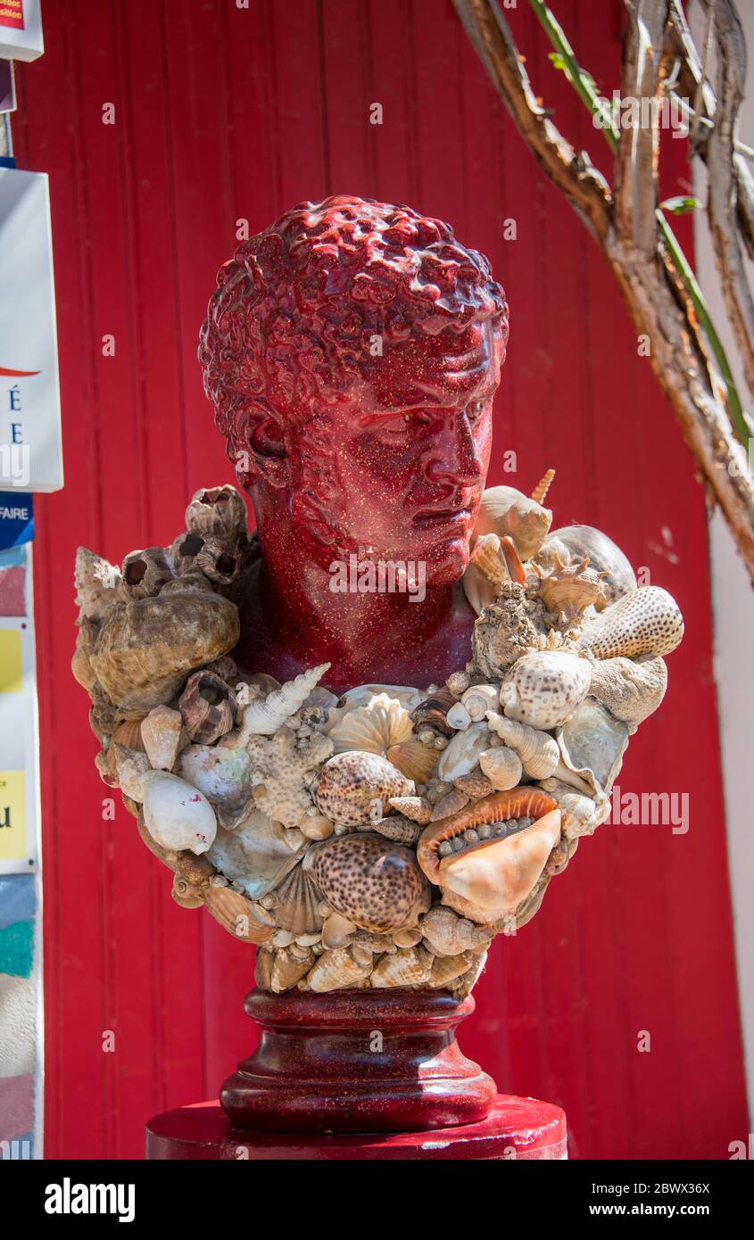 Sculptured bust of male figure with seashell garland Stock Photo