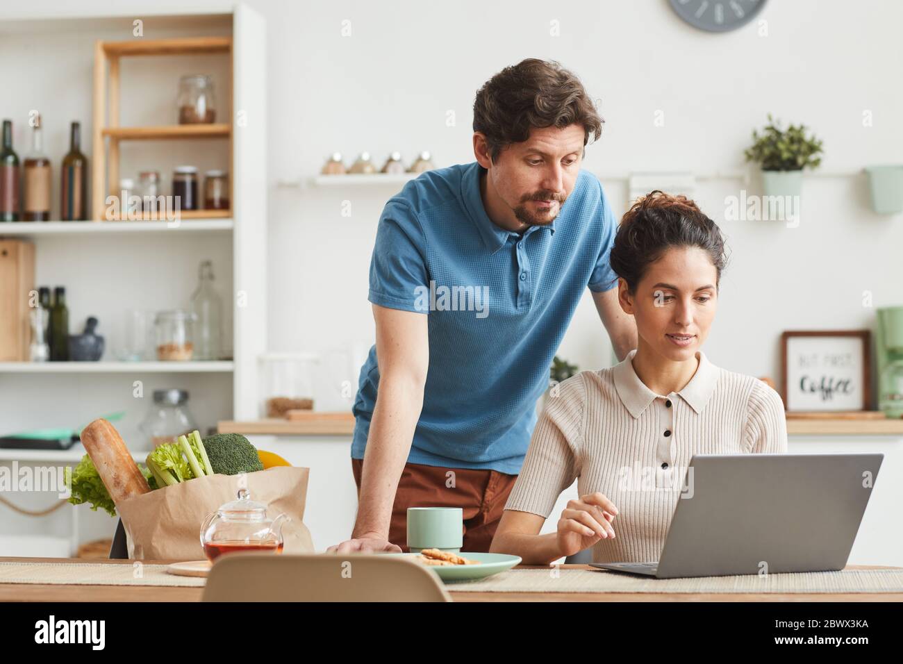 Young couple using laptop computer at home they ordering products online Stock Photo