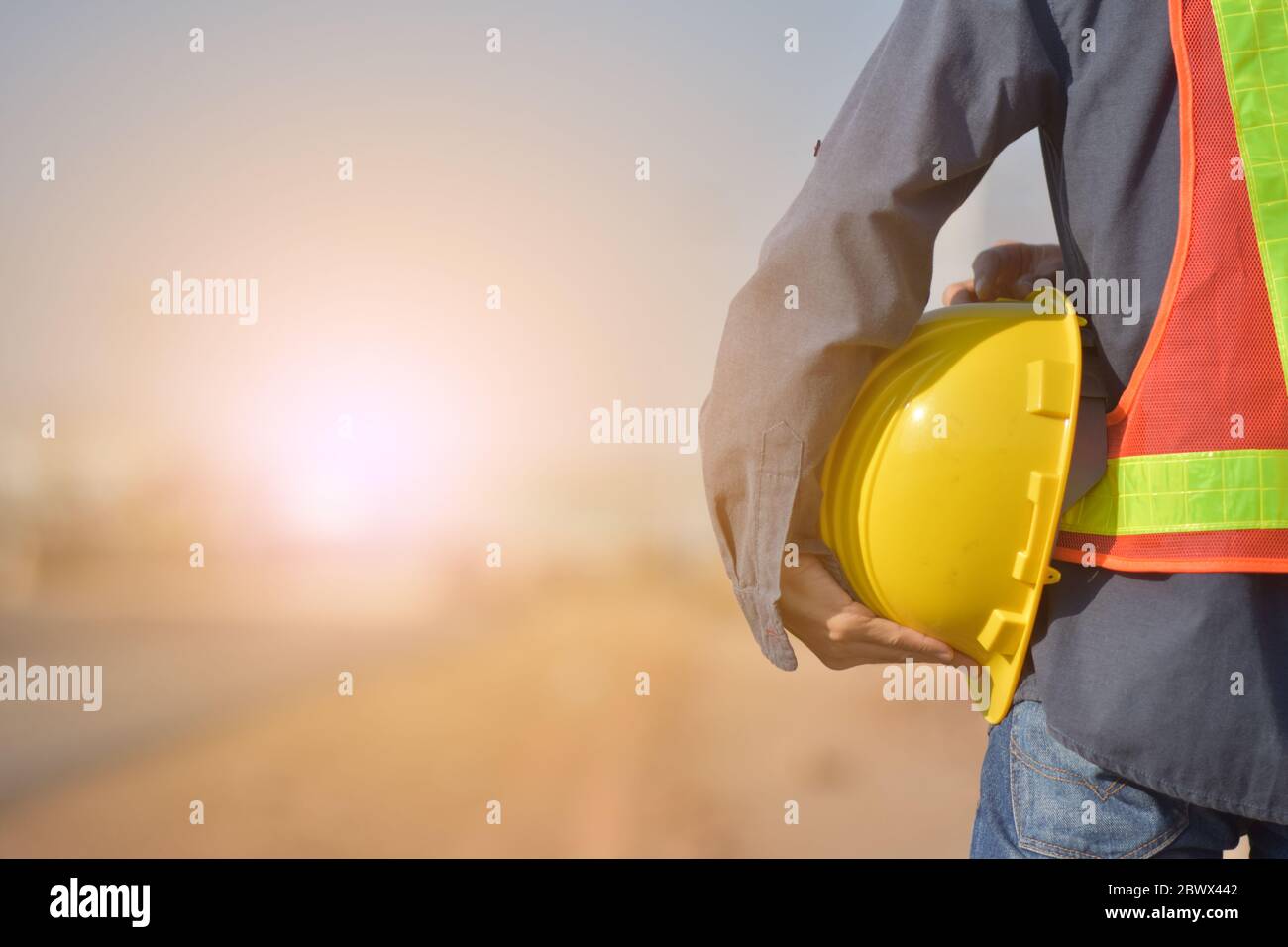 Close up Engineering holding Yellow helmet hard hat safety and Road