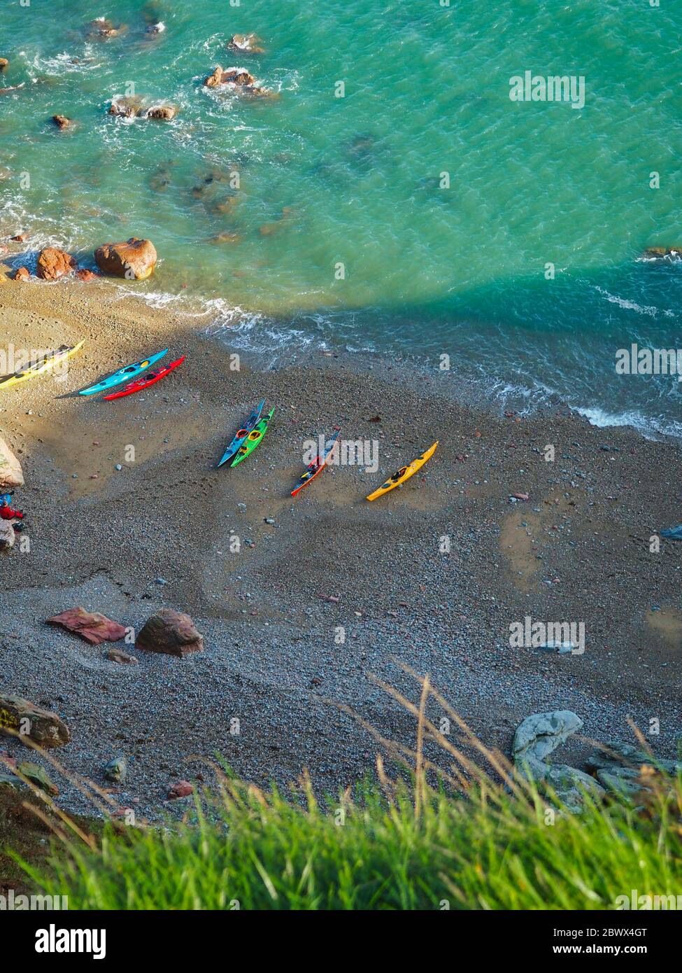 Sea kayaks on the beach in Ireland, sun and sea, a tiny hidden beach