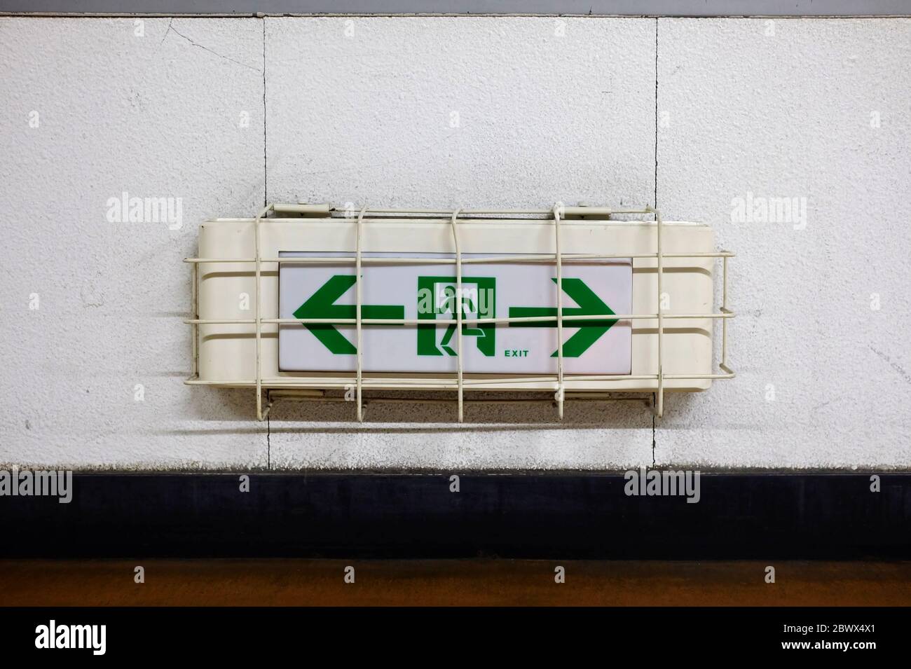 Emergency Exit Sign on Wall. Stock Photo