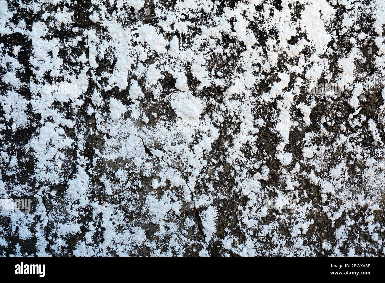 White Stucco Stains on Broken Concrete Wall Texture Background. Stock Photo