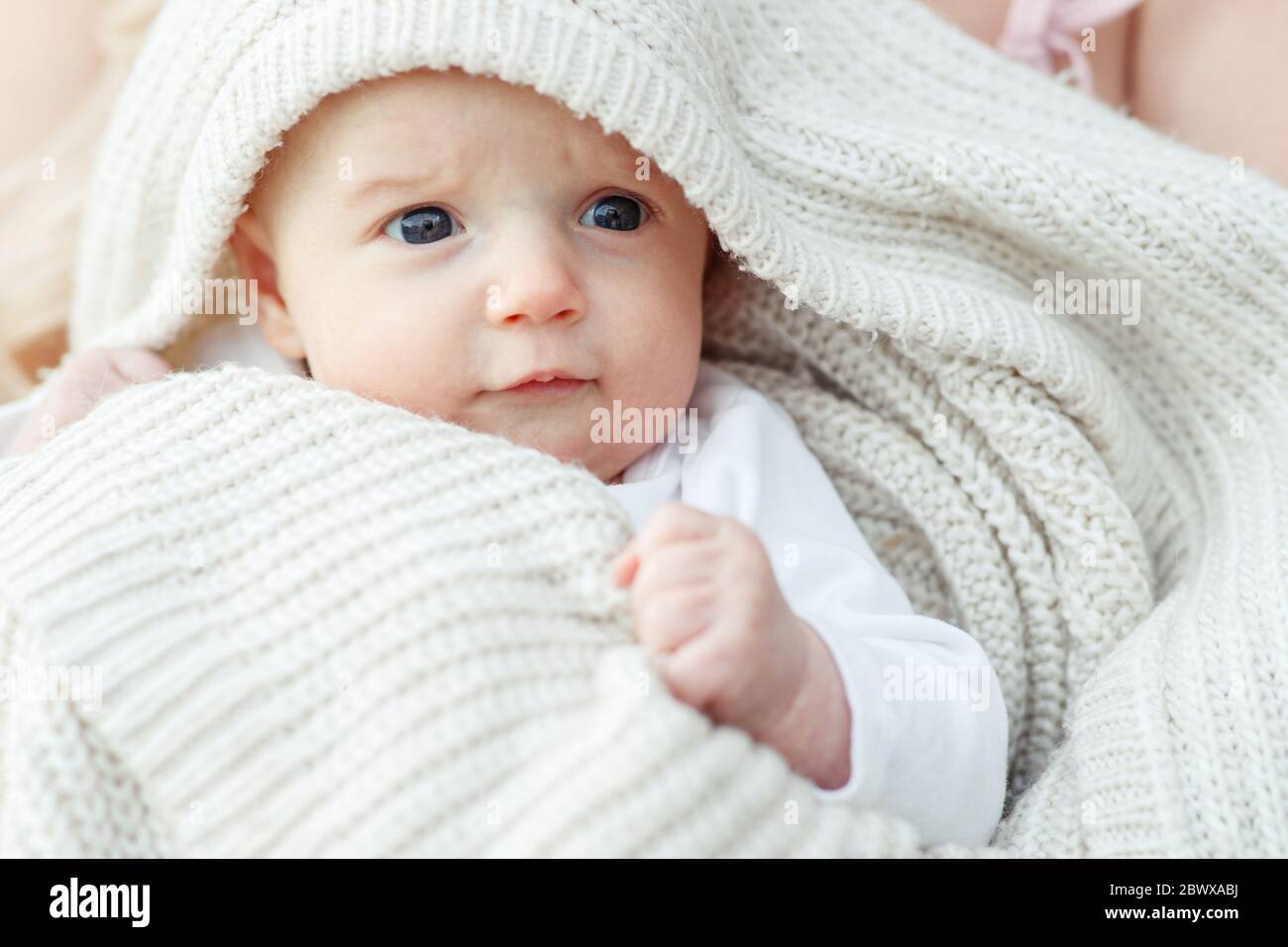 Portrait of a baby in a blanket Stock Photo Alamy