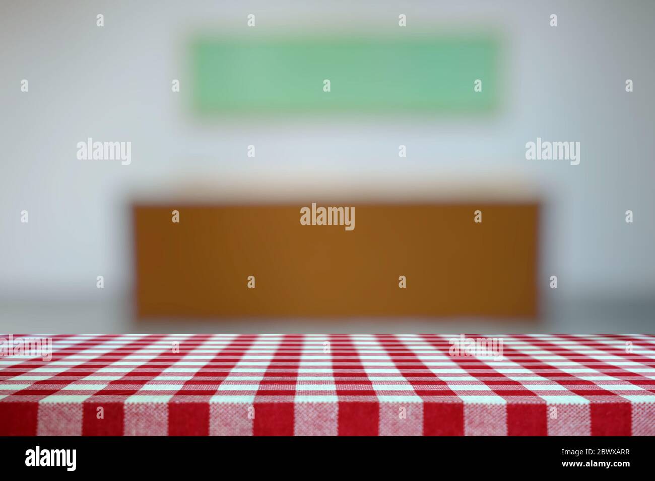 Empty Table Covered with Red Checkered Tablecloth and Blurred Art Gallery Hallway Background. Stock Photo