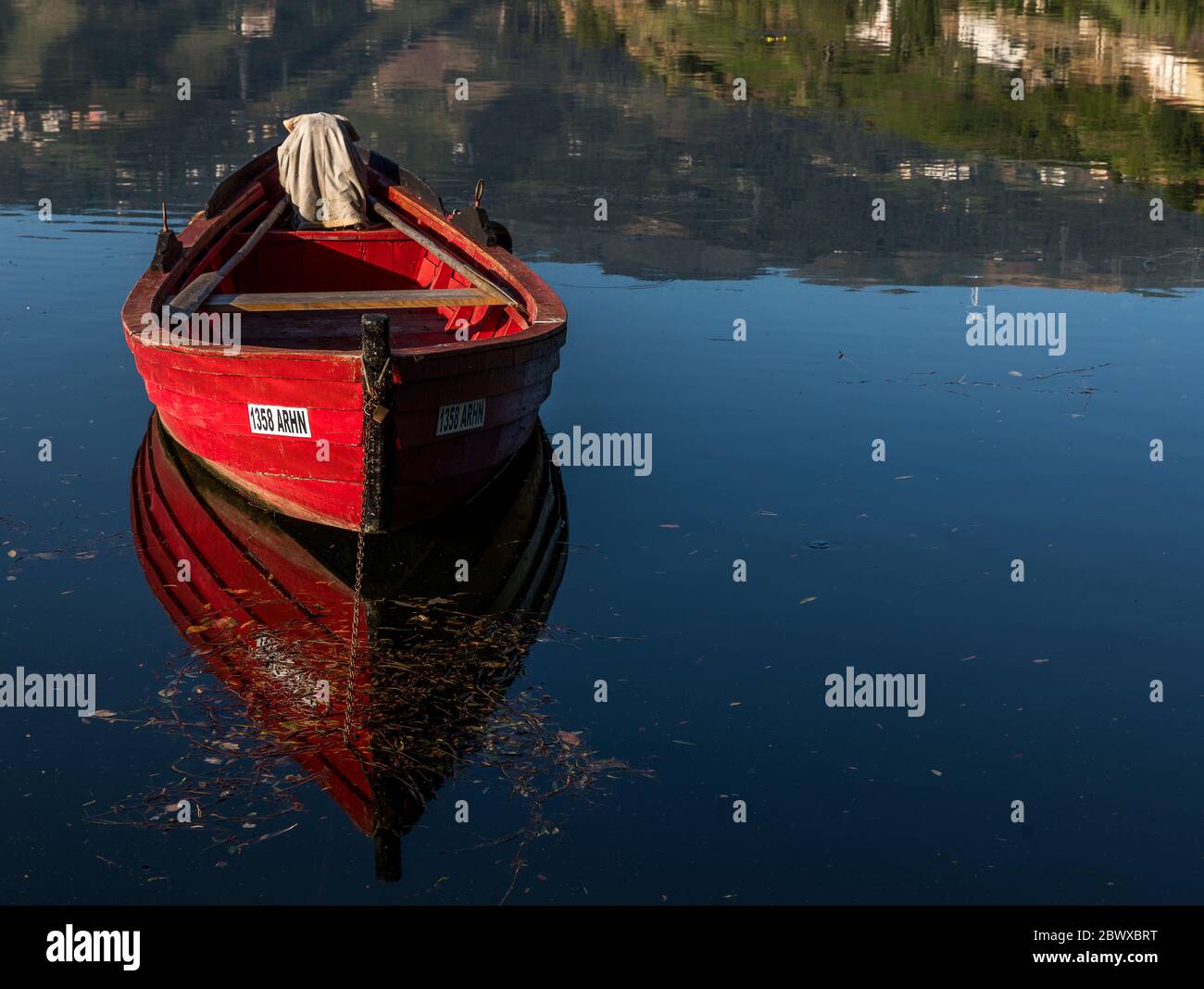 View with red traditional red fishing boat with reflections on the Douro river North Portugal Stock Photo