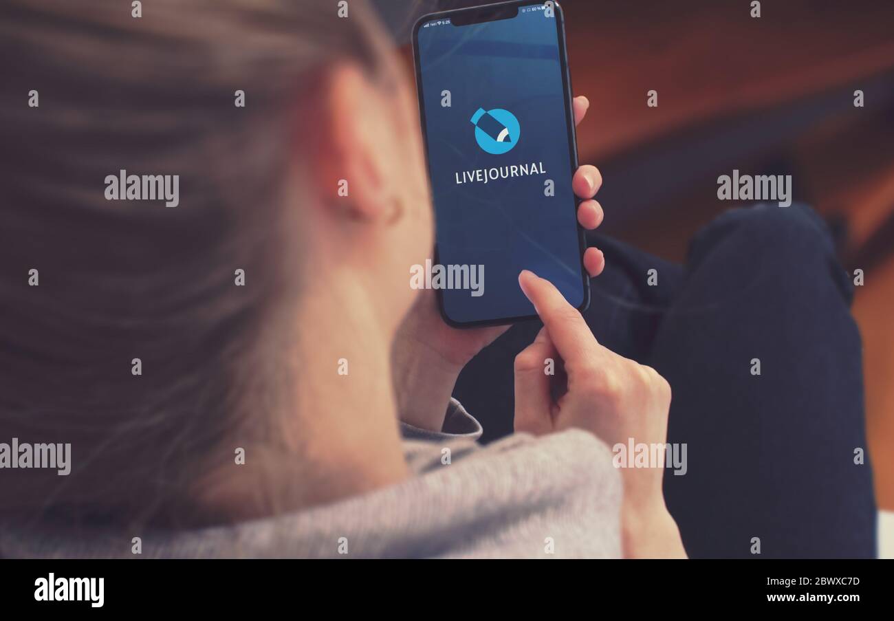 KYIV, UKRAINE-JANUARY, 2020: Livejournal on Smart Phone Screen. Young Girl Pointing or Texting Cellphone During a Pandemic Self-Isolation and Coronavirus Prevention. Stock Photo