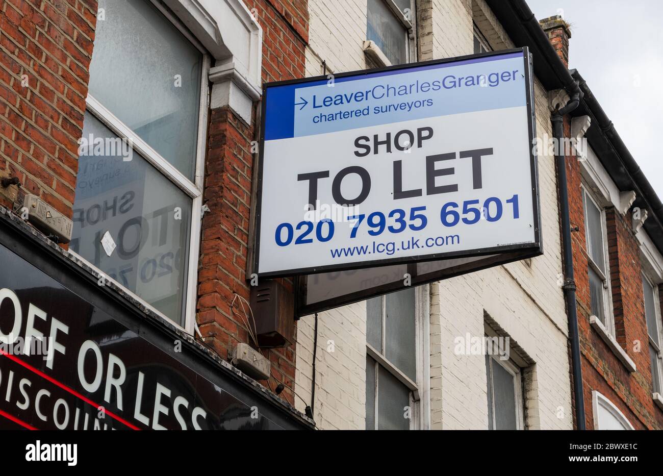 A shop to let sign above a closed down shop in Wood Green high street