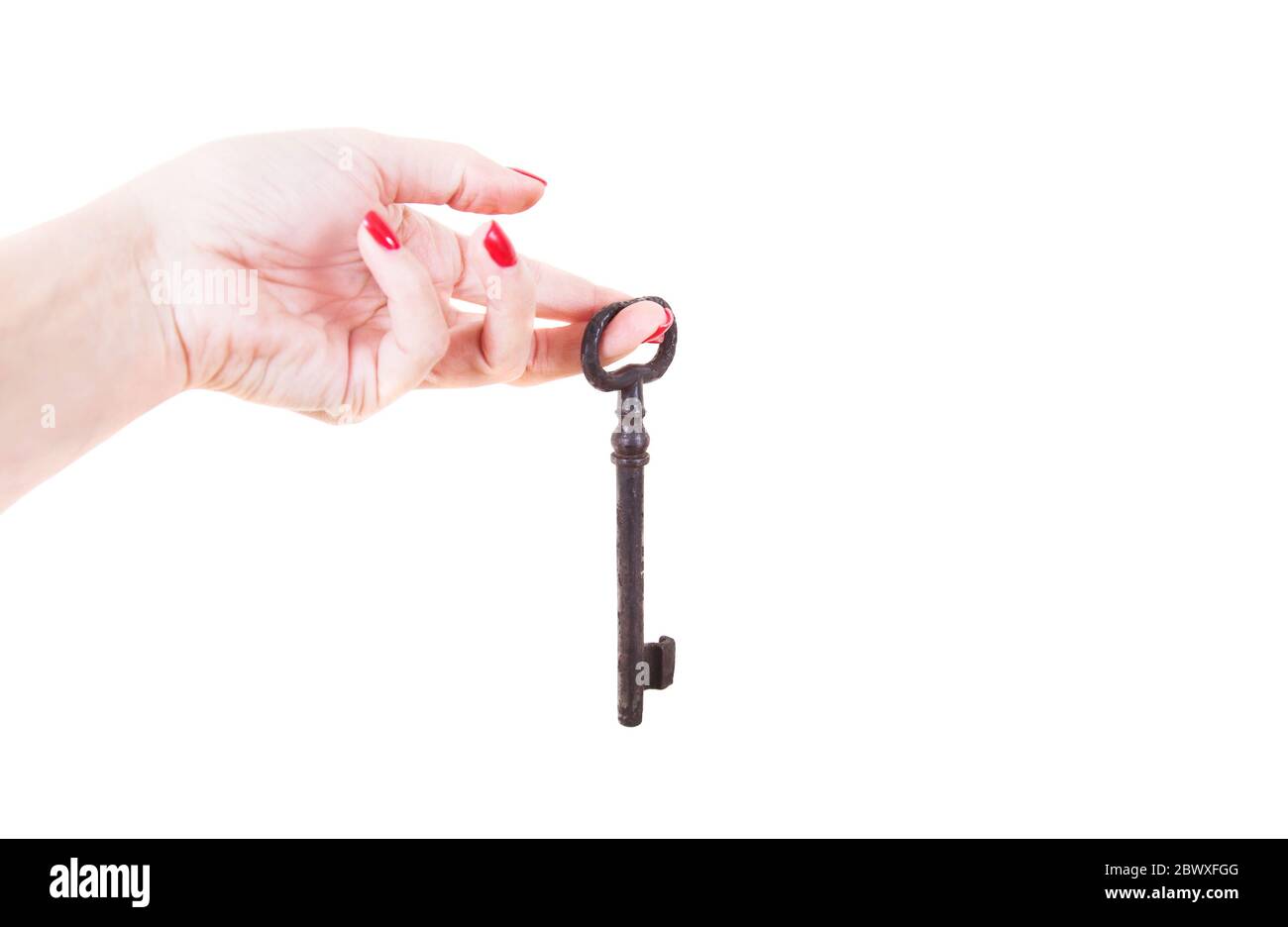 Female hand holds an old key. Isolated on white background Stock Photo ...