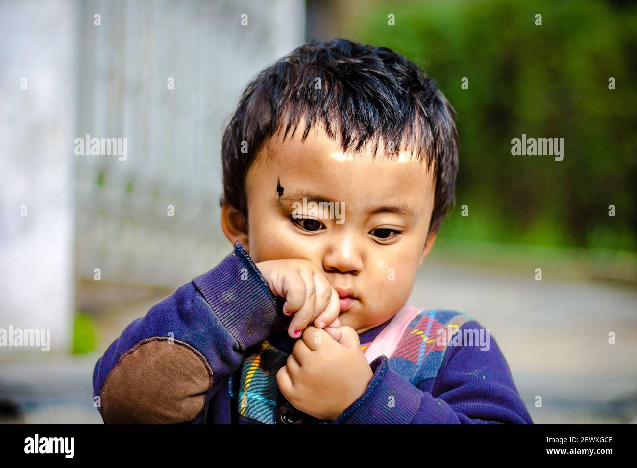 A smiling cute little child on the mall road of Dalhousie situated in Himachal Pradesh, India, Asia. Meeting locals while travelling in Himachal's best Stock Photo