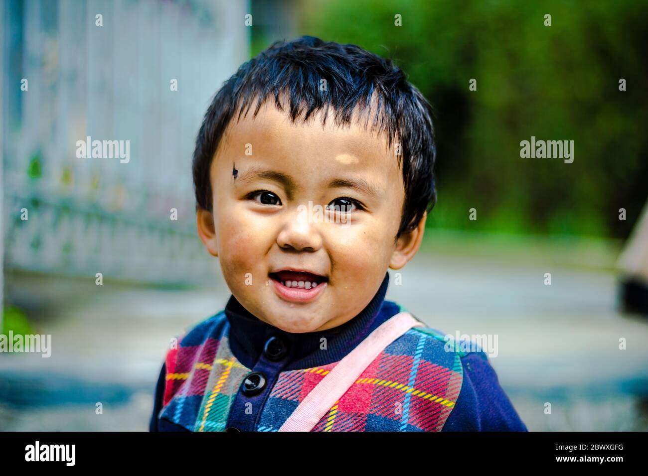 A smiling cute little child on the mall road of Dalhousie situated in Himachal Pradesh, India, Asia. Meeting locals while travelling in Himachal's best Stock Photo