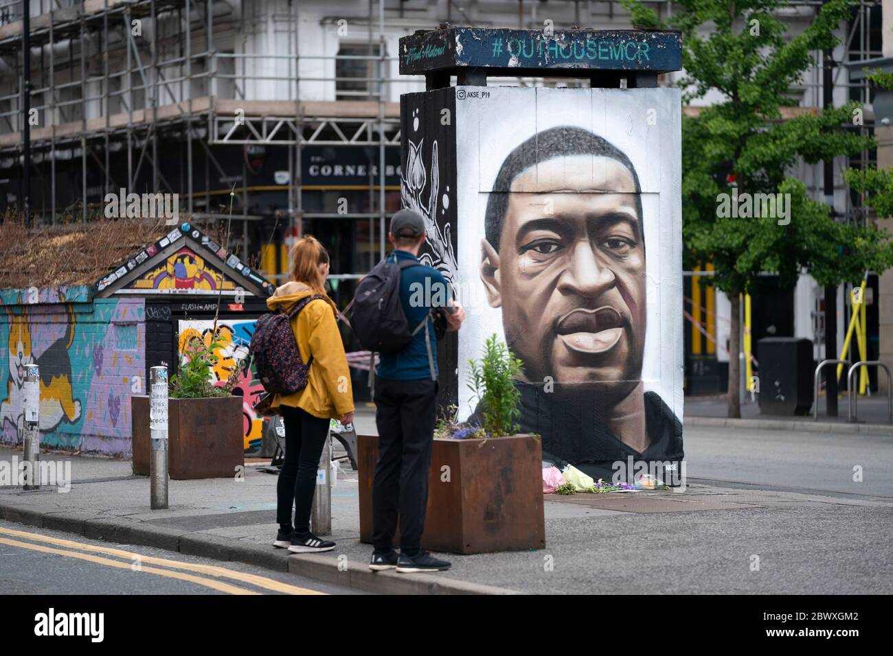 Manchester, UK. 3rd June, 2020. Members of the public are seen by a mural of George Floyd the 46-year-old black man who died in Minneapolis, Minnesota on May 25th after Derek Chauvin, a white officer with the Minneapolis Police Department, pressed his knee to Floyd's neck, Manchester, UK. Credit: Jon Super/Alamy Live News. Stock Photo