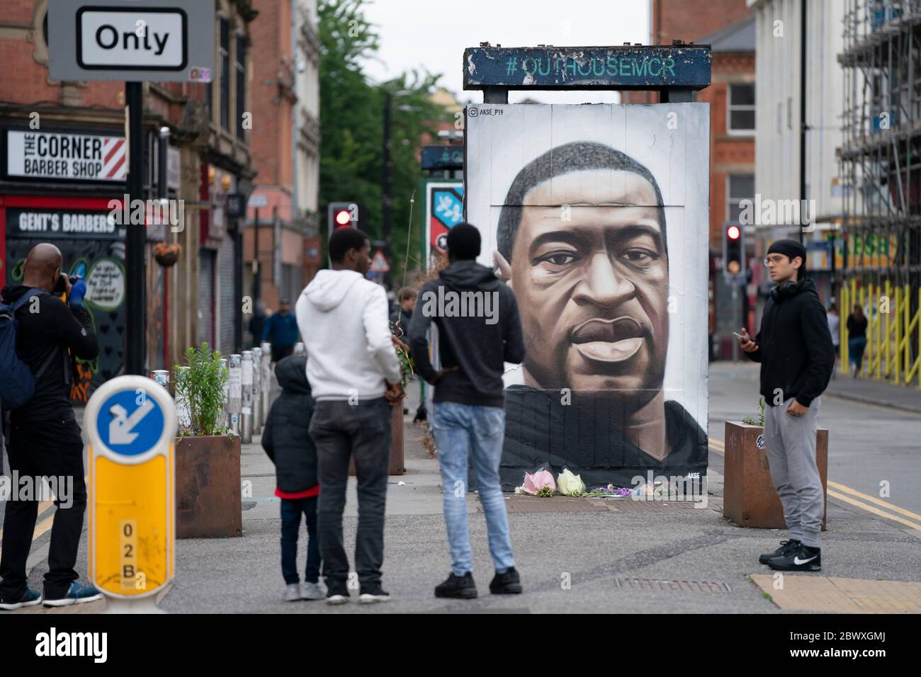 Manchester, UK. 3rd June, 2020. Members of the public are seen by a mural of George Floyd the 46-year-old black man who died in Minneapolis, Minnesota on May 25th after Derek Chauvin, a white officer with the Minneapolis Police Department, pressed his knee to Floyd's neck, Manchester, UK. Credit: Jon Super/Alamy Live News. Stock Photo