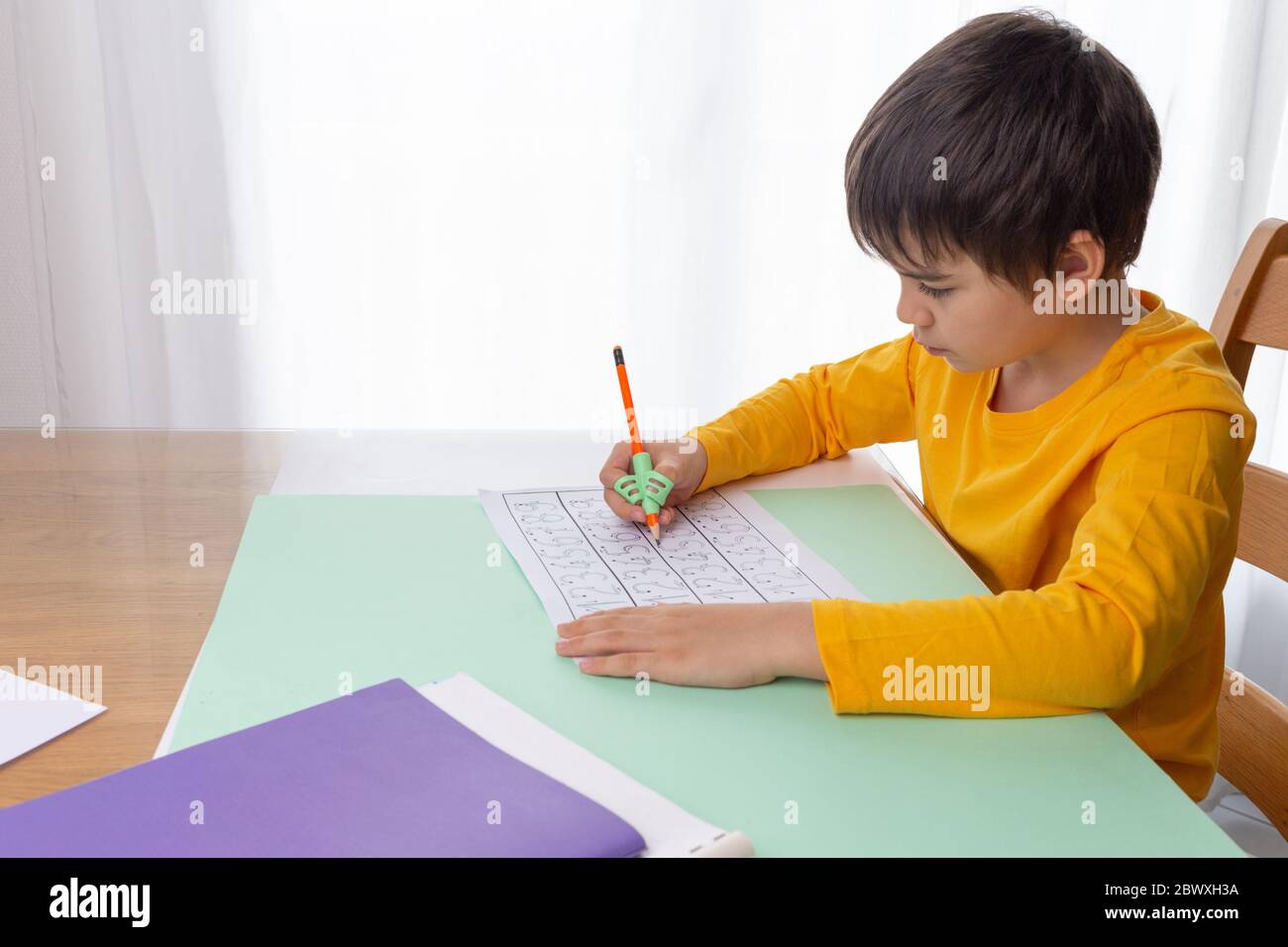 boy writing homework, handwriting correction tool, preschool writing
