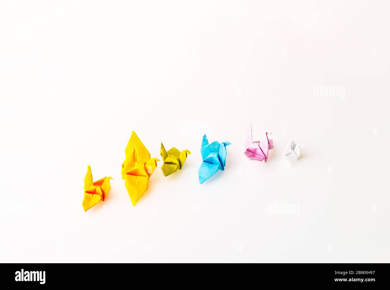 Diffirent Mini Size and Color Birds Paper, Top View Origami on White Background for Copy Space Stock Photo
