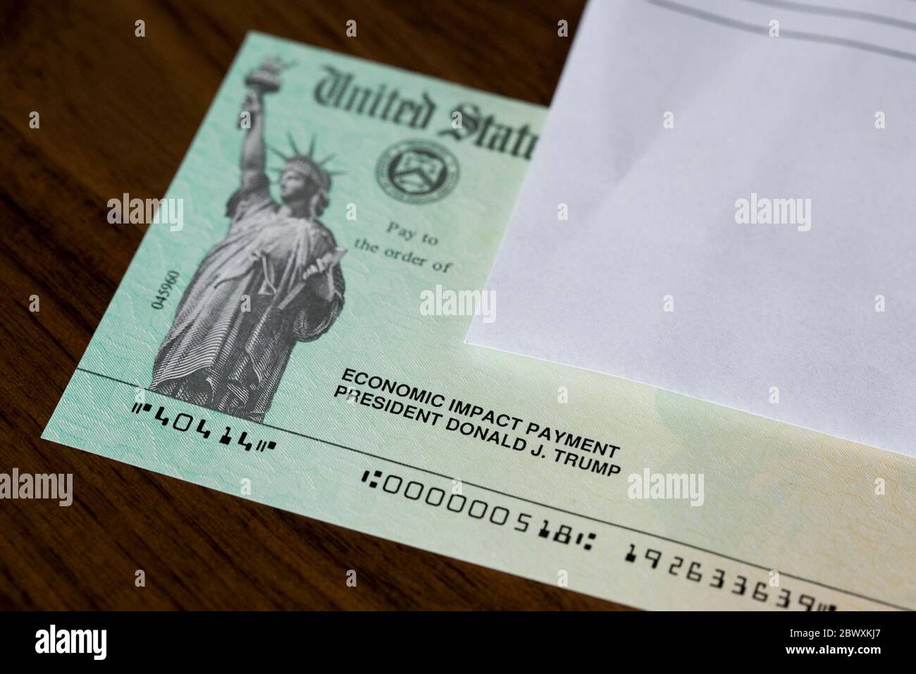 An arranged photograph of a United States Federal Government Coronavirus stimulus check, also known as the 'Economic Impact Payment' Stock Photo