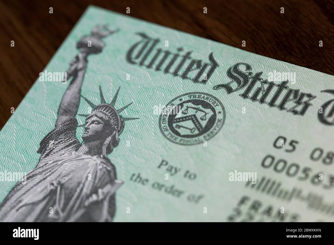 An arranged photograph of a United States Federal Government Coronavirus stimulus check, also known as the 'Economic Impact Payment' Stock Photo