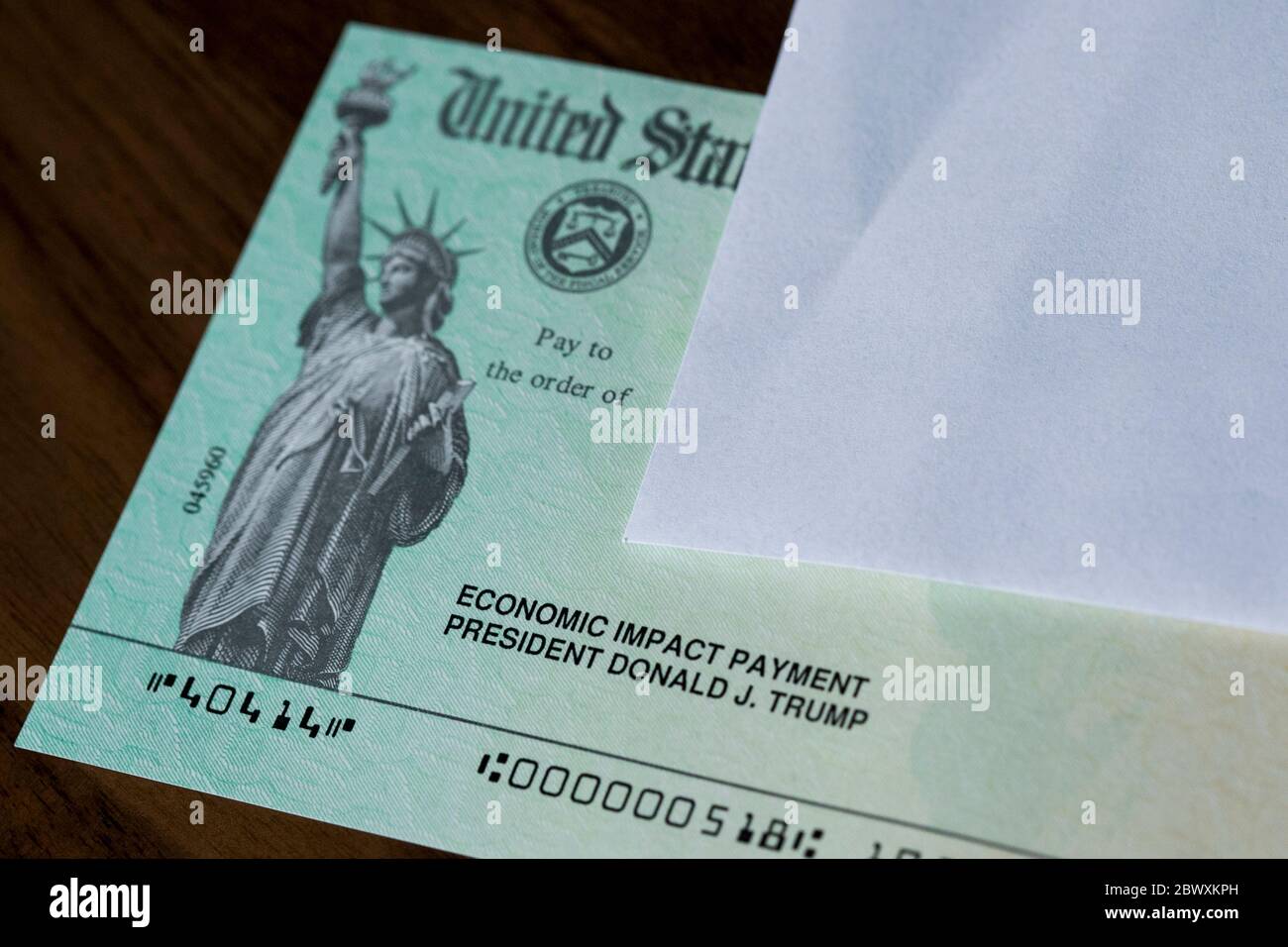 An arranged photograph of a United States Federal Government Coronavirus stimulus check, also known as the 'Economic Impact Payment' Stock Photo