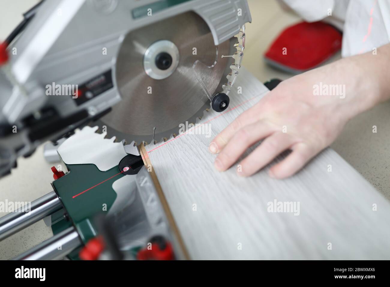 Man uses circular saw table while cutting laminate Stock Photo Alamy