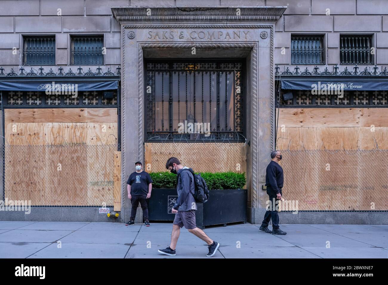 A man walks by a boarded up Saks Fifth Avenue, the iconic New York City ...