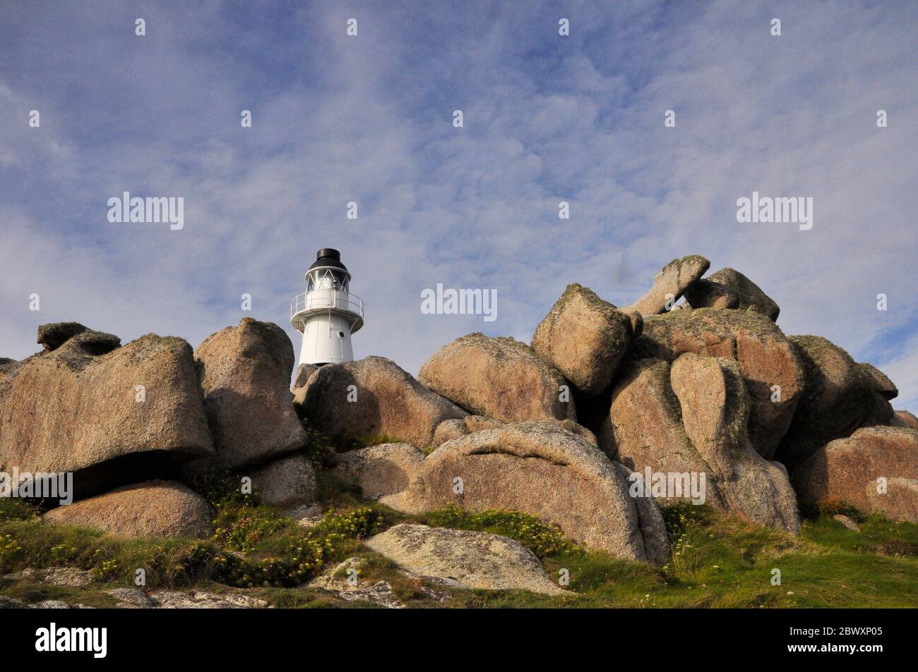 The lighthouse among the wind and water eroded granite rocks on Peninnis Head on The island of St mary's, Isles of Scilly. Cornwall .UK Stock Photo