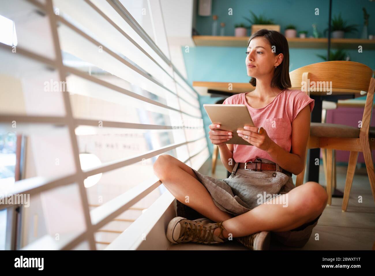 Portrait of pretty student or businesswoman in smart casual using digital tablet Stock Photo