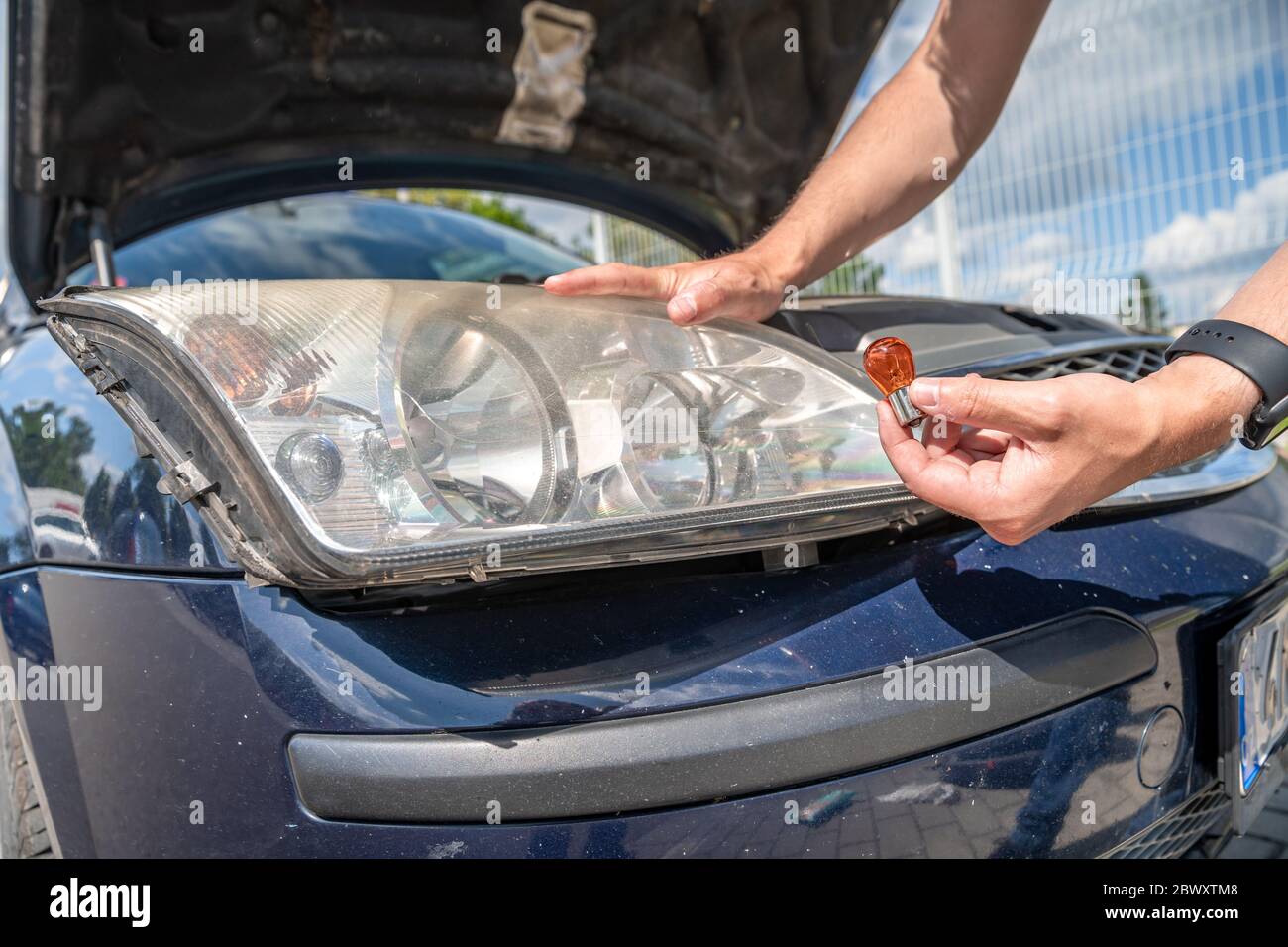 car headlight repair by replacing bad bulbs with new ones Stock Photo