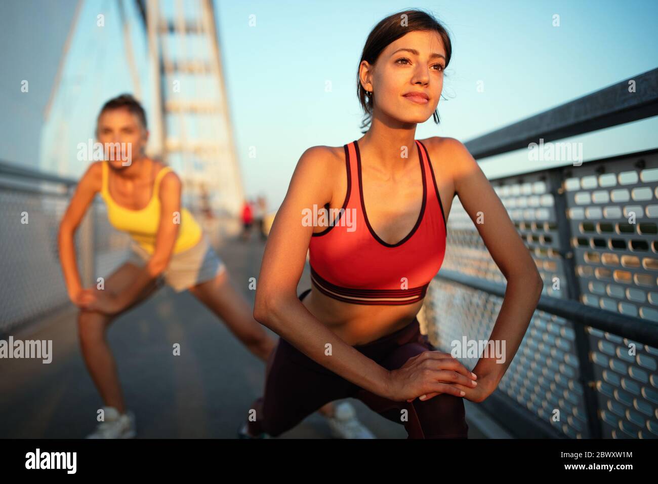 Fitness, sport, people, exercising and healthy lifestyle concept. Happy fit friends working out Stock Photo