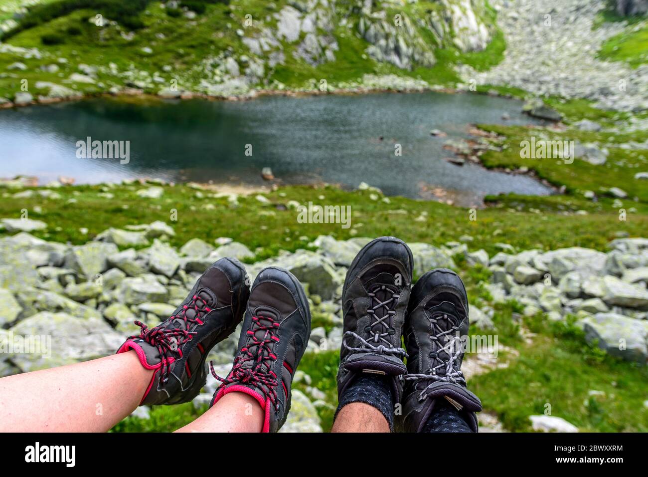 Young couple in love showing off their weary mountain boots  display picture 2