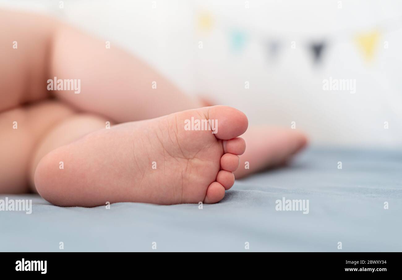 Close-up view of a caucasian baby's foot while sleeping in his bed. Stock Photo