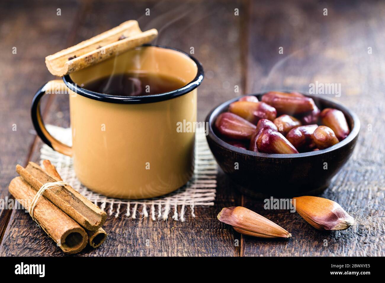 hot Brazilian wine, called "quentão", together with a portion of "pinhão" Brazilian seed cooked and served hot, drink and typical Brazilian winter foo Stock Photo