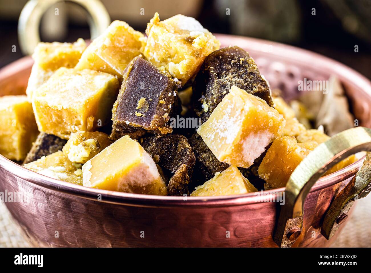 Copper pot with sugar cane-based sweets of Azorean or Canarian origin, called Rapadura, pan, cardboard, piloncillo, chancaca, empanisation and sweet t Stock Photo
