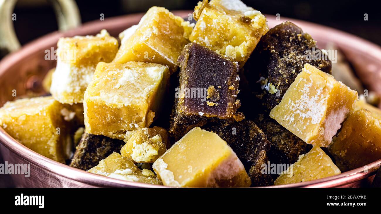 Copper pot with sugar cane-based sweets of Azorean or Canarian origin, called Rapadura, pan, cardboard, piloncillo, chancaca, empanisation and sweet t Stock Photo