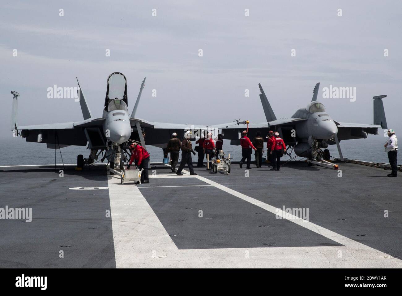 U.S. Navy Aviation Ordnancemen prepare two F/A-18E Super Hornet fighter aircraft for launch on the flight deck of the Ford-class aircraft carrier USS Gerald R. Ford May 30, 2020 in the Atlantic Ocean. Stock Photo